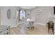 Cozy dining area with light wood floors, white table and chairs, and natural light at 1622 Lorna Dr, Henderson, NV 89011
