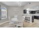 Cozy dining area with white table and chairs, light wood floors, open to kitchen at 1622 Lorna Dr, Henderson, NV 89011