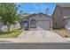 Charming single-story home featuring a clean stucco facade, two arched windows, and a one-car garage at 1622 Lorna Dr, Henderson, NV 89011