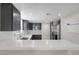 Beautiful kitchen featuring sleek, dark cabinetry, stainless steel appliances, and elegant quartz countertops at 1622 Lorna Dr, Henderson, NV 89011