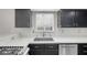 Close up of a well-equipped kitchen with stainless steel appliances and dark cabinetry at 1622 Lorna Dr, Henderson, NV 89011