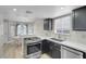 Bright, modern kitchen with stainless steel appliances, granite countertops, and an open layout at 1622 Lorna Dr, Henderson, NV 89011