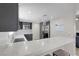 Kitchen featuring dark cabinets, stainless steel appliances, and a spacious quartz countertop at 1622 Lorna Dr, Henderson, NV 89011