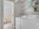 Convenient laundry area featuring wire shelving and neutral tile to the bathroom at 1622 Lorna Dr, Henderson, NV 89011
