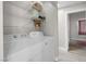 Convenient laundry area featuring wire shelving and neutral tile to the living spaces at 1622 Lorna Dr, Henderson, NV 89011
