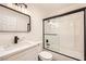 Modern bathroom with updated vanity, stone countertop, framed mirror, and sleek glass shower doors at 1829 E Saint Louis Ave, Las Vegas, NV 89104