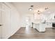 Modern kitchen featuring white cabinets, stone countertops, stainless steel appliances, and updated flooring at 1829 E Saint Louis Ave, Las Vegas, NV 89104