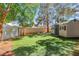 A landscaped backyard area featuring artificial turf, a putting green, and a storage shed at 1931 Pago Ct, Las Vegas, NV 89117