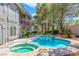 Inviting backyard oasis featuring a sparkling pool and spa surrounded by lush landscaping at 1931 Pago Ct, Las Vegas, NV 89117