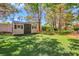 Landscaped backyard with a putting green and storage shed for outdoor activities at 1931 Pago Ct, Las Vegas, NV 89117