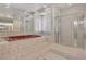Bright bathroom featuring tiled floors and a jacuzzi tub with a separate glass shower at 1931 Pago Ct, Las Vegas, NV 89117