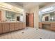 Bright bathroom with double vanity, tile flooring and light wood cabinets at 1931 Pago Ct, Las Vegas, NV 89117