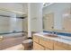 Bathroom with tile countertop and backsplash, glass-enclosed shower, and pink fixtures at 1931 Pago Ct, Las Vegas, NV 89117