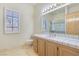 Bright bathroom featuring a built-in vanity with double sinks and a separate shower with glass doors at 1931 Pago Ct, Las Vegas, NV 89117