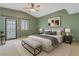 A serene bedroom features a neutral palette with a ceiling fan and access to an outdoor space at 1931 Pago Ct, Las Vegas, NV 89117