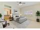 Relaxing bedroom with a sitting area, a ceiling fan, and a bright natural light at 1931 Pago Ct, Las Vegas, NV 89117
