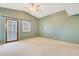 Spacious bedroom featuring vaulted ceilings, neutral carpeting, and a private door to the backyard at 1931 Pago Ct, Las Vegas, NV 89117