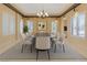 Formal dining room featuring a modern chandelier, large oval table, and seating for eight at 1931 Pago Ct, Las Vegas, NV 89117