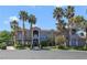 Eye-catching two-story house with manicured lawns and many palm trees at 1931 Pago Ct, Las Vegas, NV 89117