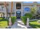 Up-close view of two-story home featuring lion statues and lush bushes at 1931 Pago Ct, Las Vegas, NV 89117