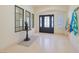 Welcoming foyer featuring a decorative front door, tiled floor, and ample natural light at 1931 Pago Ct, Las Vegas, NV 89117