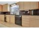 Kitchen featuring stone countertops and backsplash, wooden cabinets and stainless steel appliances at 1931 Pago Ct, Las Vegas, NV 89117