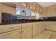 Kitchen featuring granite countertops, wooden cabinets and open to the living room at 1931 Pago Ct, Las Vegas, NV 89117