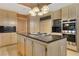 Modern kitchen with stainless steel appliances, center island with cooktop, and stylish cabinets at 1931 Pago Ct, Las Vegas, NV 89117