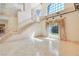 Bright living room boasting stairs and large windows with designer curtains at 1931 Pago Ct, Las Vegas, NV 89117