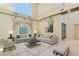 Bright living room with high ceilings, neutral tones, large windows, and comfortable modern furnishings at 1931 Pago Ct, Las Vegas, NV 89117
