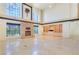 Expansive living room with a fireplace, large windows, and built-in shelving, filled with natural light at 1931 Pago Ct, Las Vegas, NV 89117
