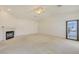 A comfortable living room featuring a charming fireplace, bright lighting, and a sliding door at 1931 Pago Ct, Las Vegas, NV 89117
