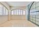 Bright, open room featuring stone floors and plenty of natural light from large arched windows at 1931 Pago Ct, Las Vegas, NV 89117