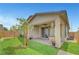 Well-maintained backyard featuring plants, artificial turf, and a covered patio at 2238 Thelen Ave, North Las Vegas, NV 89086