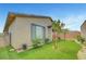 Well-manicured backyard featuring artificial turf, decorative rock, and lush landscaping for outdoor enjoyment at 2238 Thelen Ave, North Las Vegas, NV 89086