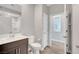 Bathroom features an undermount sink, tile backsplash, and framed mirror at 2238 Thelen Ave, North Las Vegas, NV 89086
