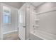 Bright bathroom featuring a tub and shower combination and wood-look flooring at 2238 Thelen Ave, North Las Vegas, NV 89086