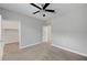 Large bedroom offers a walk-in closet, neutral carpet, and ceiling fan at 2238 Thelen Ave, North Las Vegas, NV 89086