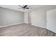 Neutral bedroom showcasing wood-look flooring, a ceiling fan, and fresh paint at 2238 Thelen Ave, North Las Vegas, NV 89086