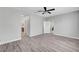 Spacious bedroom with wood-look floors and base trim plus access to an en-suite bathroom and a walk-in closet at 2238 Thelen Ave, North Las Vegas, NV 89086