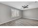 Bedroom with hardwood flooring, a ceiling fan, base trim, and large shuttered windows offering lots of natural light at 2238 Thelen Ave, North Las Vegas, NV 89086