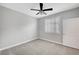 Neutral bedroom offers a ceiling fan with light and window with plantation shutters at 2238 Thelen Ave, North Las Vegas, NV 89086