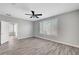 Bright bedroom features wood-look floors, modern fan, and plantation shutters for natural light at 2238 Thelen Ave, North Las Vegas, NV 89086