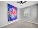 Cozy bedroom features a ceiling fan, window with shutters, and modern accents at 2238 Thelen Ave, North Las Vegas, NV 89086