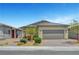 Charming single-story home featuring a paver driveway, desert landscaping, and a two-car garage at 2238 Thelen Ave, North Las Vegas, NV 89086