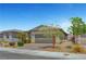 Beautiful single-story home featuring desert landscaping, paver driveway, and a two-car garage at 2238 Thelen Ave, North Las Vegas, NV 89086