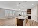 Open concept kitchen with island, granite countertops, and stainless steel appliances flowing into living area with lots of natural light at 2238 Thelen Ave, North Las Vegas, NV 89086