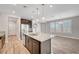 Open-concept kitchen with a central island, granite countertops, and stainless steel appliances, seamlessly connecting to the living space at 2238 Thelen Ave, North Las Vegas, NV 89086