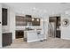 Modern kitchen with stainless steel appliances, a center island with barstool seating, and granite countertops at 2238 Thelen Ave, North Las Vegas, NV 89086