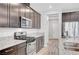 Modern kitchen with granite countertops, stainless steel appliances, and a gas range stove at 2238 Thelen Ave, North Las Vegas, NV 89086